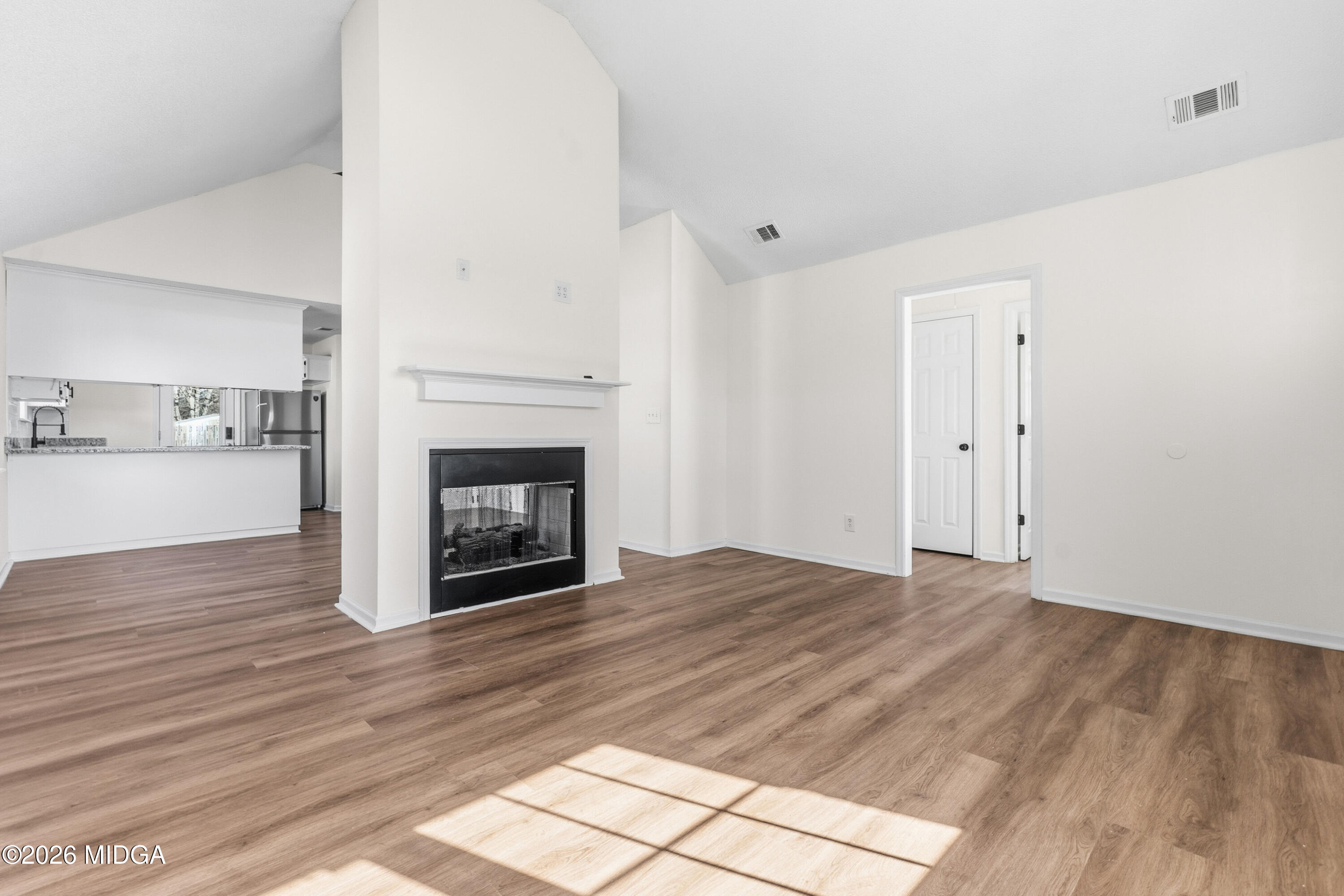 404 Wynfield Lane Bonaire, GA 31005 - Photo 4 of 45 a view of empty room with wooden floor and fireplace