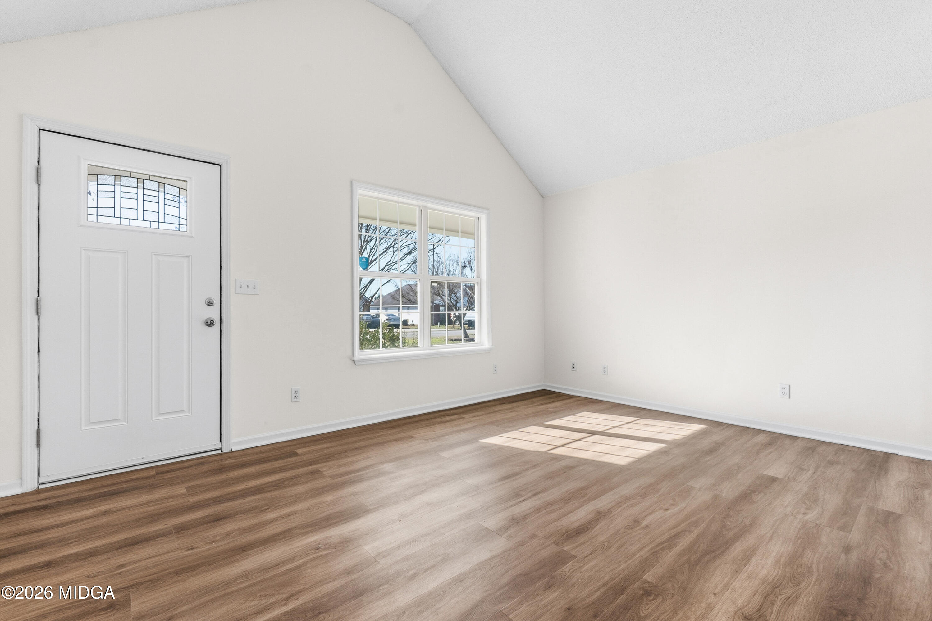 404 Wynfield Lane Bonaire, GA 31005 - Photo 7 of 45 an empty room with wooden floor and windows