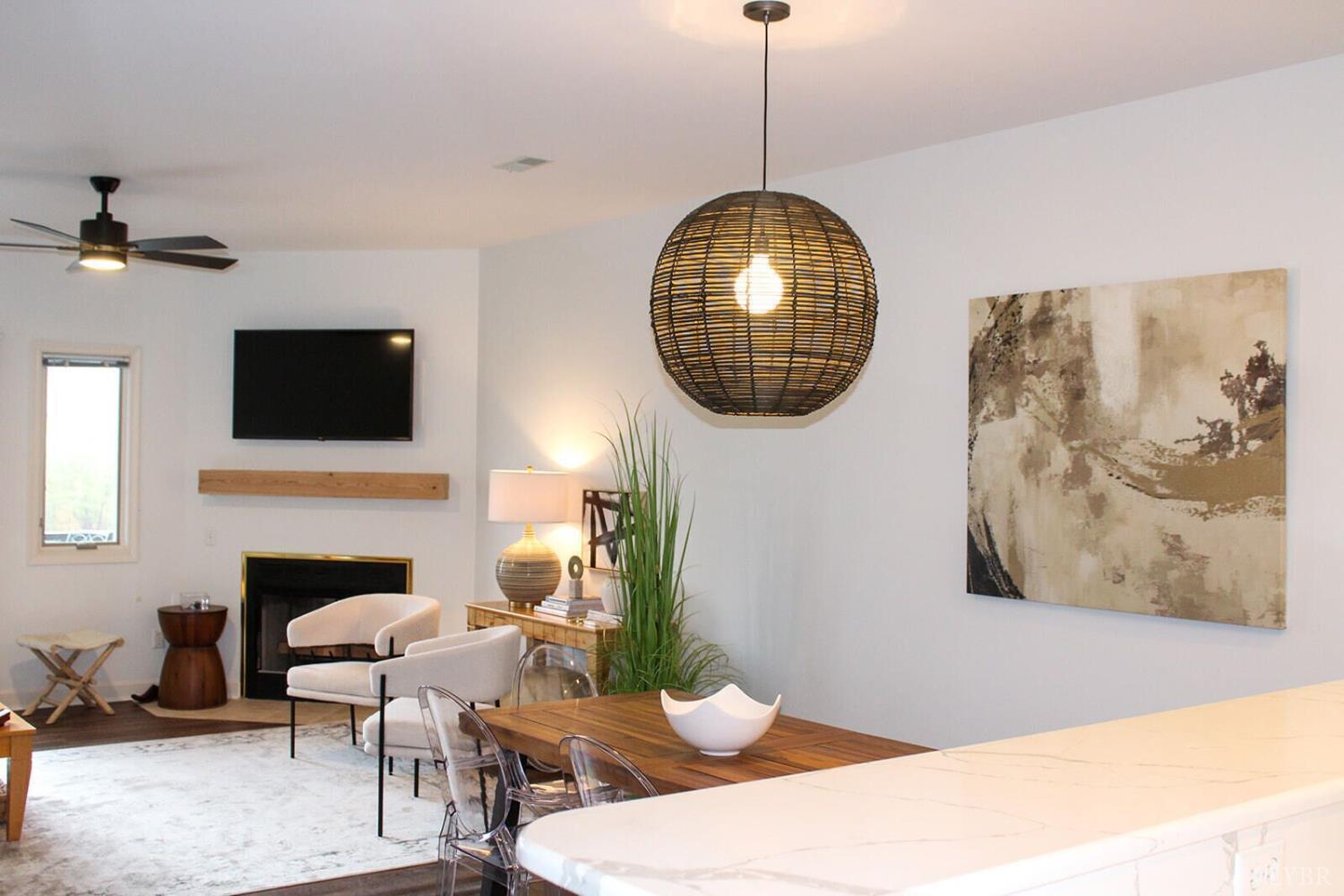 1019 Mariners Way, Unit 30 Huddleston, VA 24104 - Photo 13 of 48 a living room with furniture a fireplace and a flat screen tv