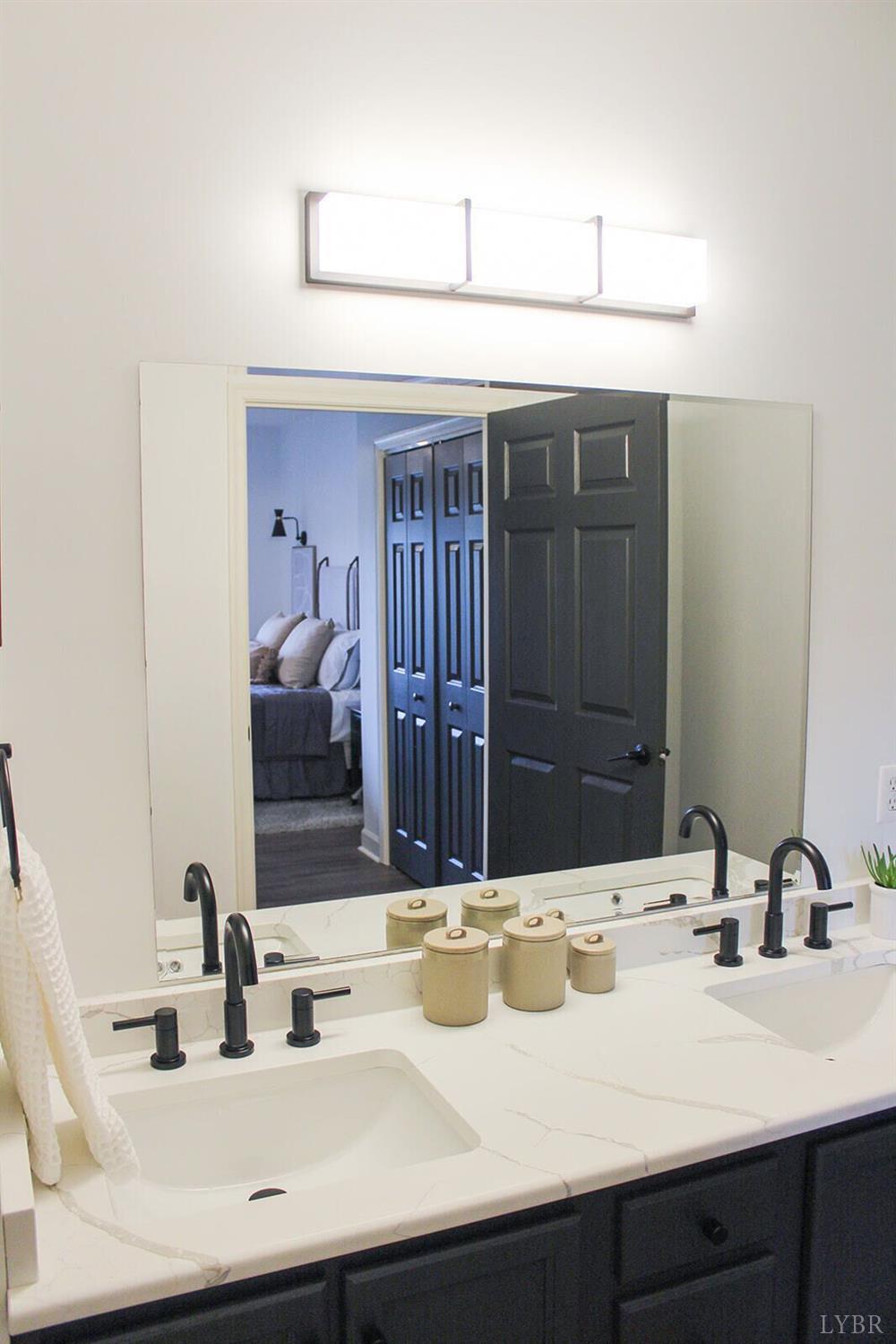 1019 Mariners Way, Unit 30 Huddleston, VA 24104 - Photo 28 of 48 a bathroom with a sink and a mirror