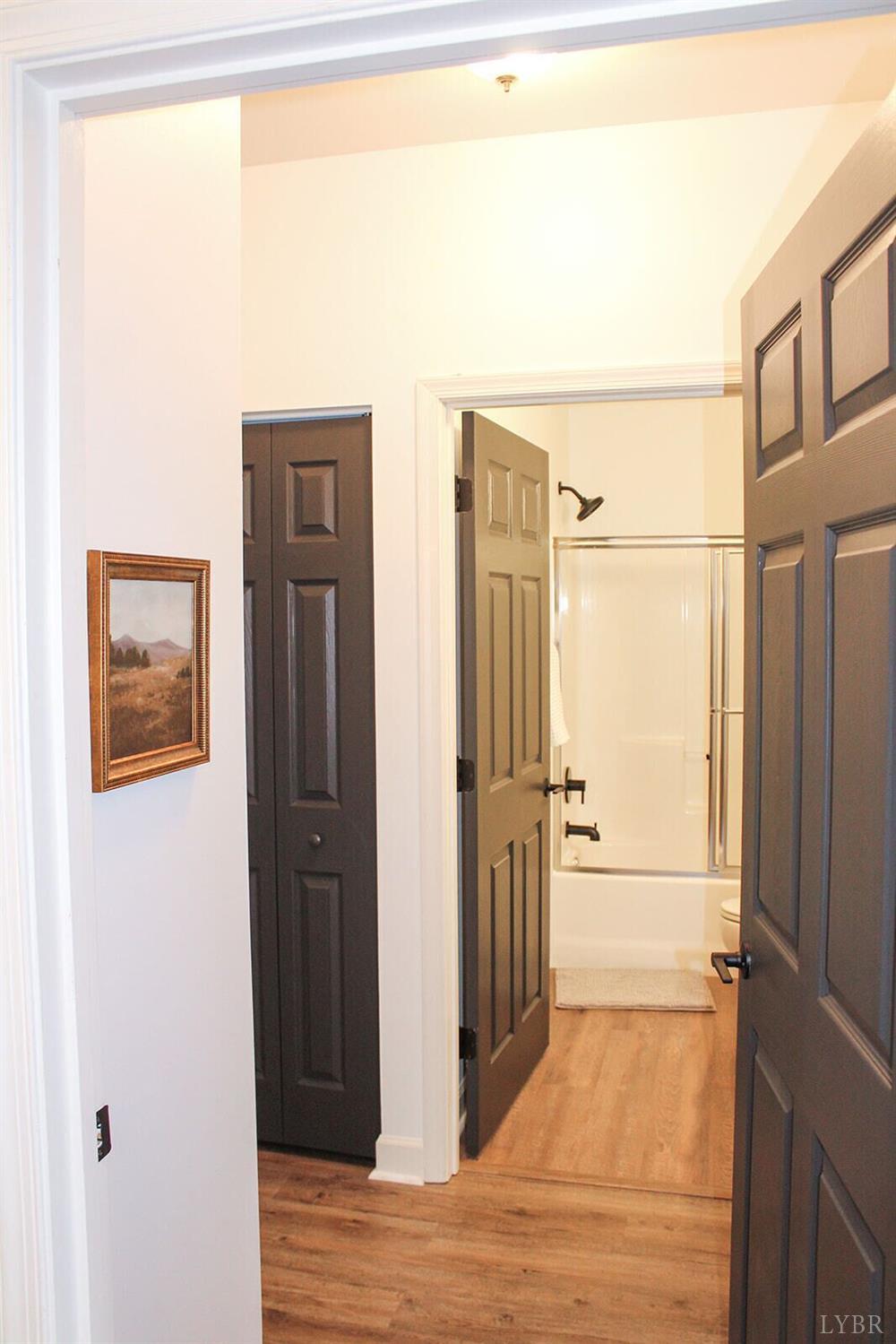 1019 Mariners Way, Unit 30 Huddleston, VA 24104 - Photo 31 of 48 a view of a hallway with a refrigerator and wooden floor
