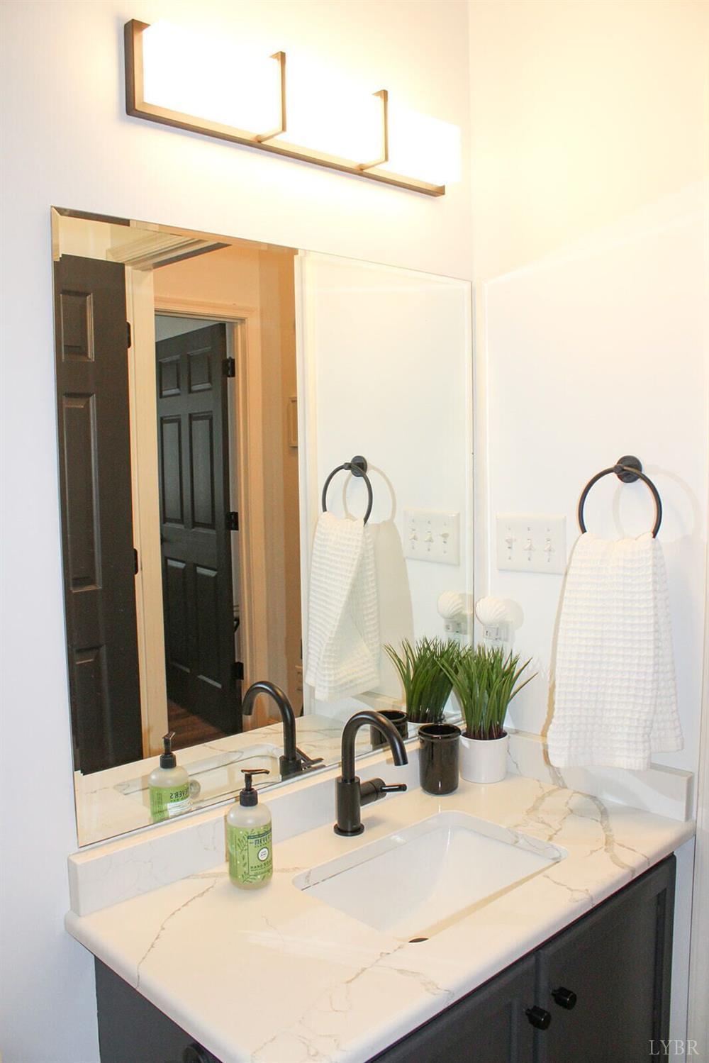 1019 Mariners Way, Unit 30 Huddleston, VA 24104 - Photo 35 of 48 a bathroom with a sink and a mirror