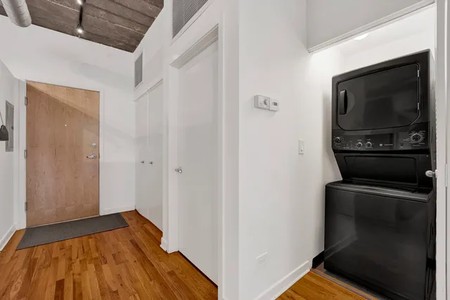 a view of a livingroom with wooden floor and staircase
