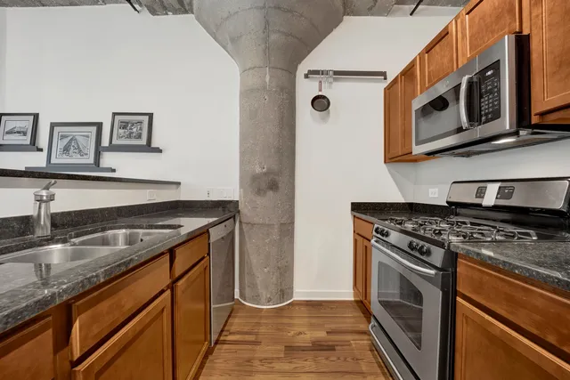 a kitchen with granite countertop a sink and a stove top oven