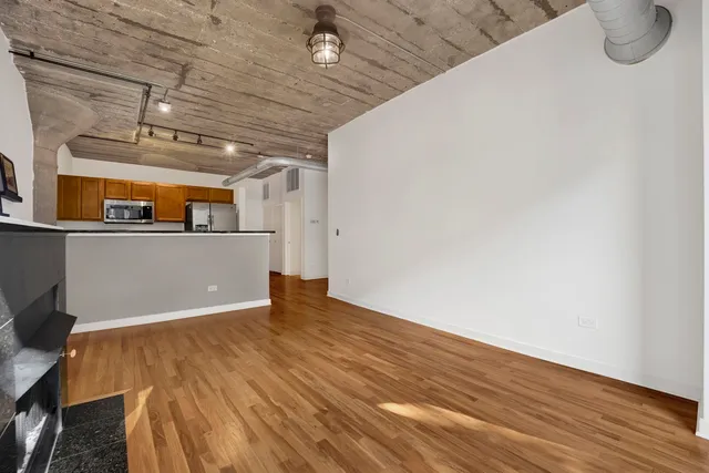a view of a room with wooden floor