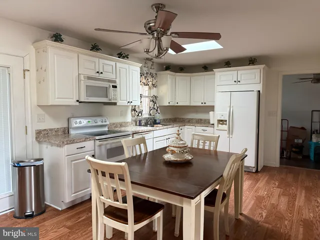 a kitchen with cabinets a counter space stainless steel appliances and cabinets