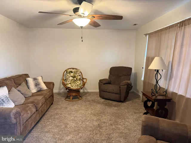 a living room with furniture and a mirror