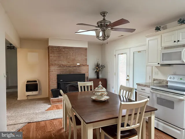 a view of a dining room with furniture a kitchen and chandelier