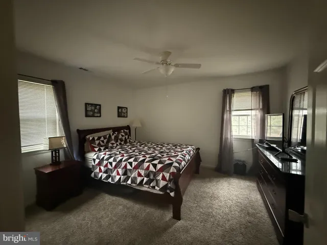 a bedroom with a bed next to a window