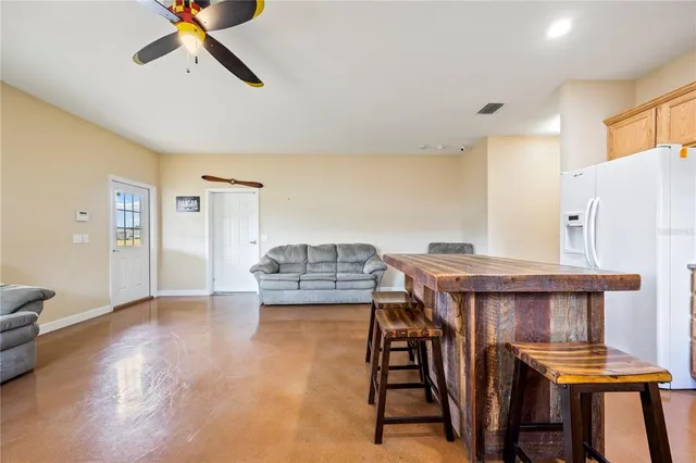 a view of a livingroom with furniture and staircase