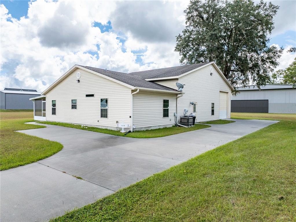 168 Southwest Poberezny Glen Lake Lake City, FL 32025 - Photo 4 of 29 a view of a white house with a big yard and large trees