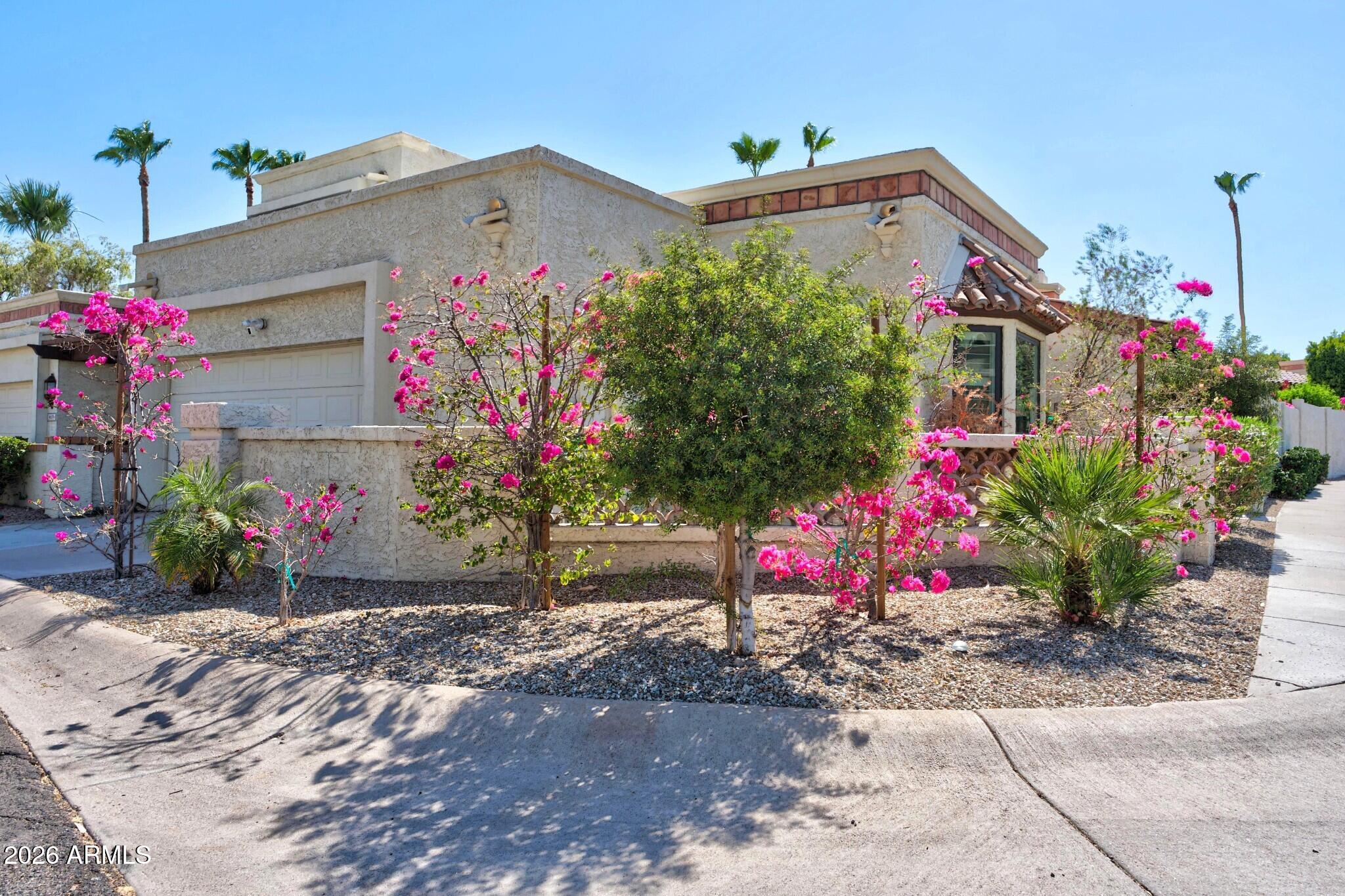 4615 East Monte Way Phoenix, AZ 85044 - Photo 1 of 35 a front view of house with flowers
