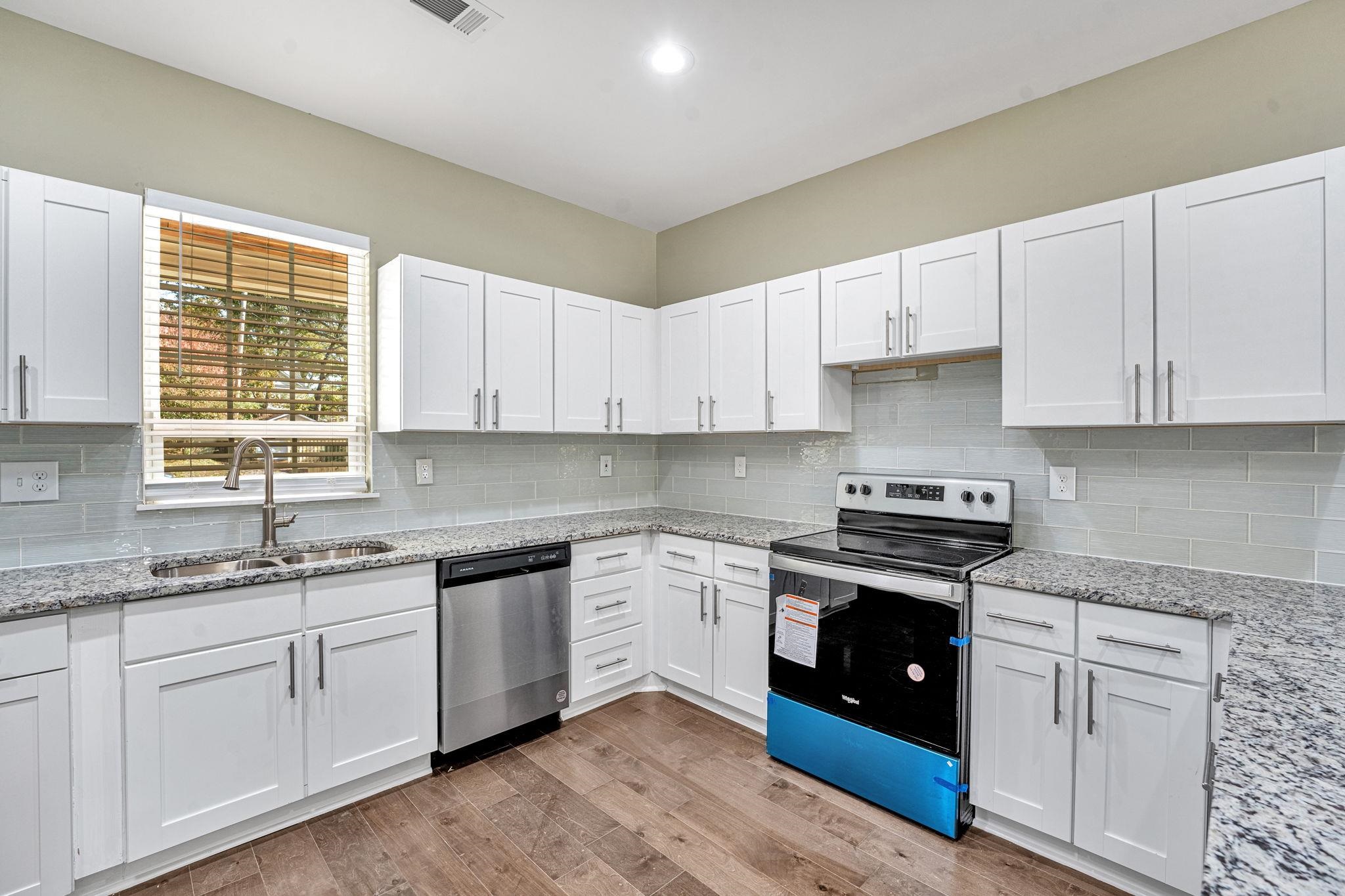 71 Clark Place Memphis, TN 38104 - Photo 3 of 11 a kitchen with stainless steel appliances granite countertop a stove sink and cabinets