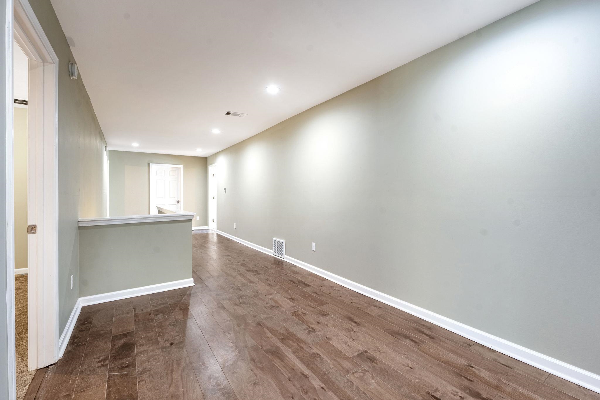 71 Clark Place Memphis, TN 38104 - Photo 8 of 11 a view of an empty room with wooden floor