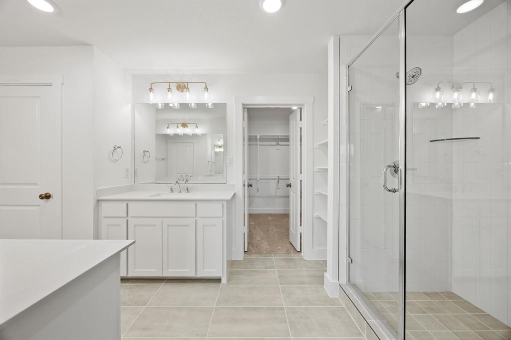 316 Chestnut Street Celina, TX 75009 - Photo 16 of 25 a bathroom with a double vanity sink mirror and shower