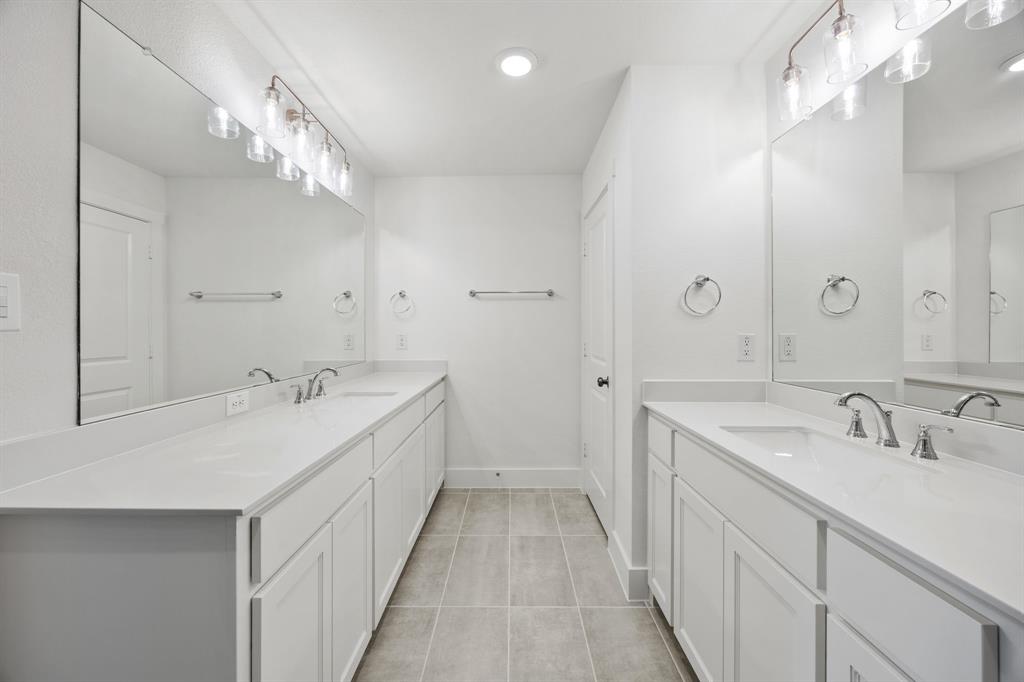 316 Chestnut Street Celina, TX 75009 - Photo 17 of 25 a spacious bathroom with a double vanity sink and mirror