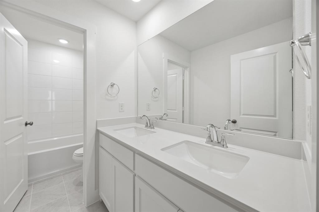 316 Chestnut Street Celina, TX 75009 - Photo 19 of 25 a bathroom with a sink double vanity granite tub shower and a mirror