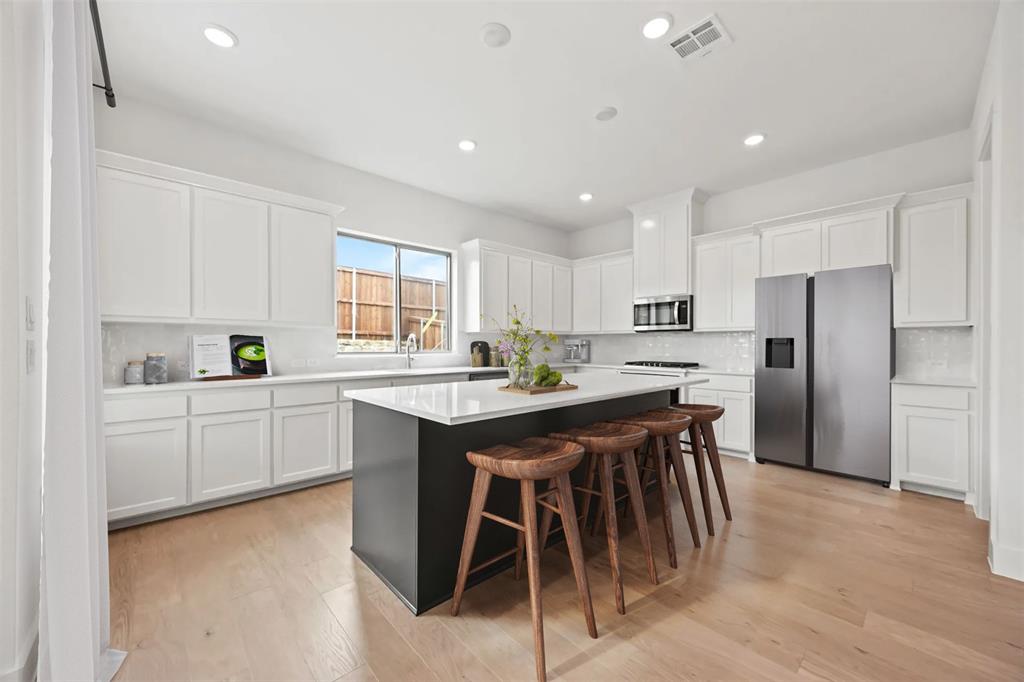 316 Chestnut Street Celina, TX 75009 - Photo 6 of 25 a kitchen with a table and chairs in it