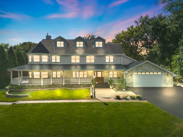 a view of a house with a big yard and a large tree