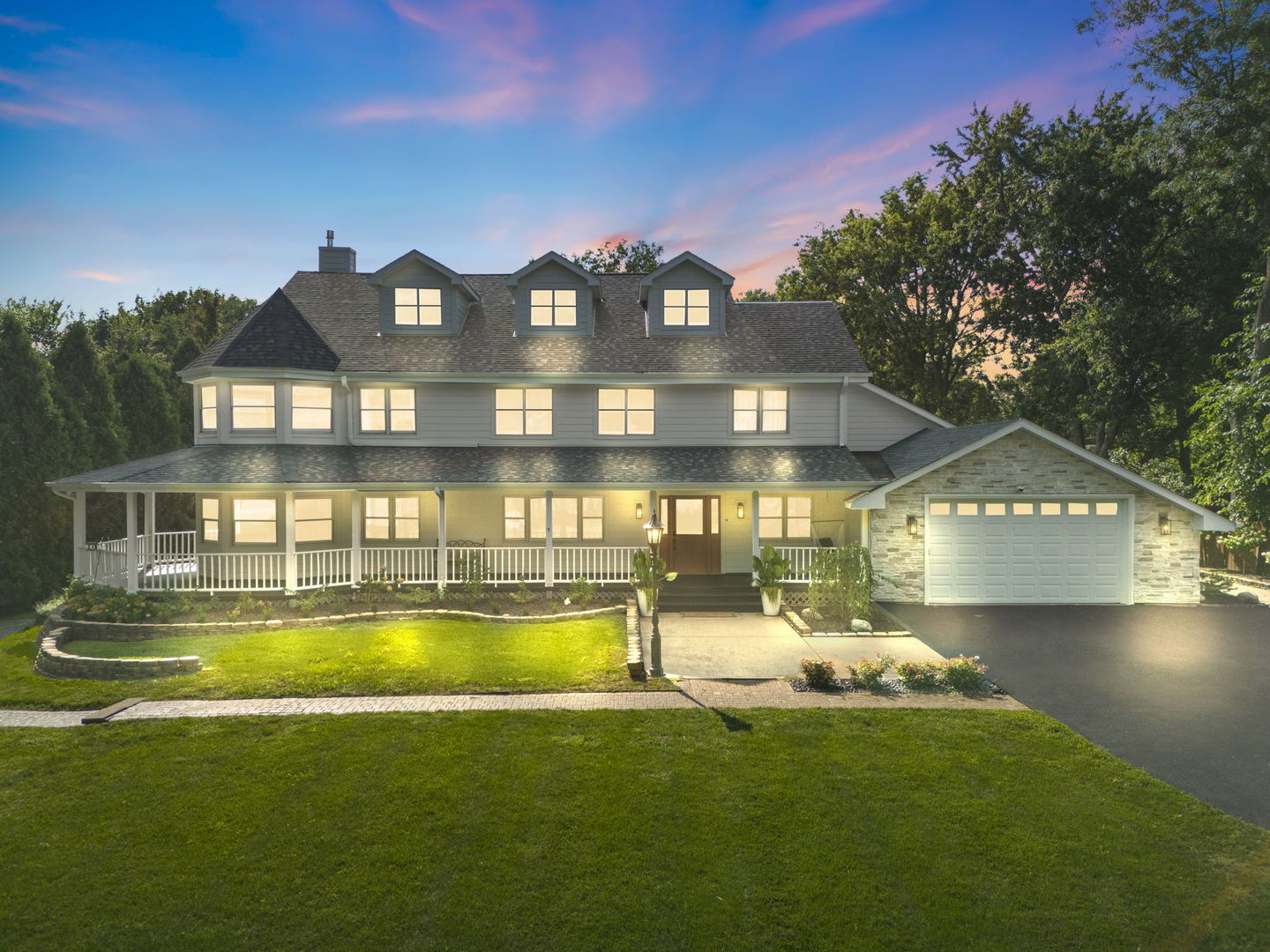 a view of a house with a big yard and a large tree