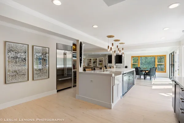 a kitchen with stainless steel appliances granite countertop a refrigerator and a sink