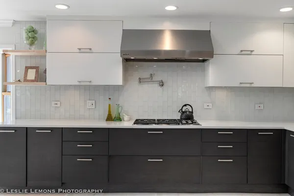 a living room with stainless steel appliances kitchen island granite countertop a refrigerator and a stove top oven