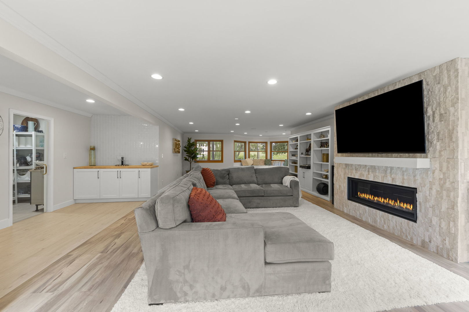 8S452 Bell Drive Naperville, IL 60565 - Photo 18 of 59 a living room with furniture a fireplace and a flat screen tv