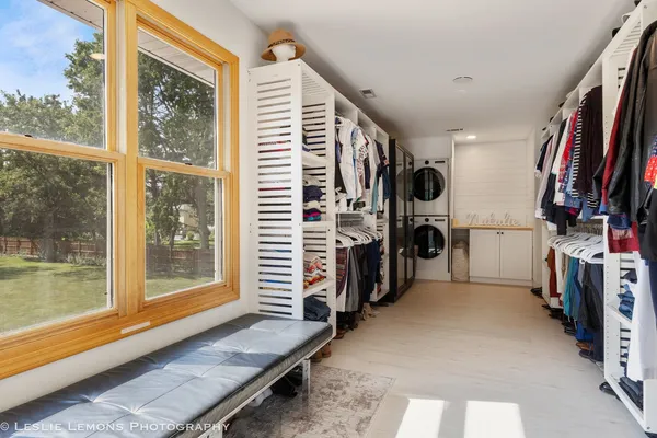 a spacious bedroom with a bed and a lamp