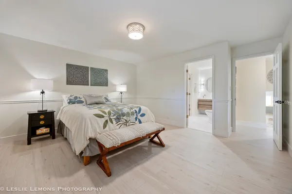 a spacious bedroom with a bed and a window