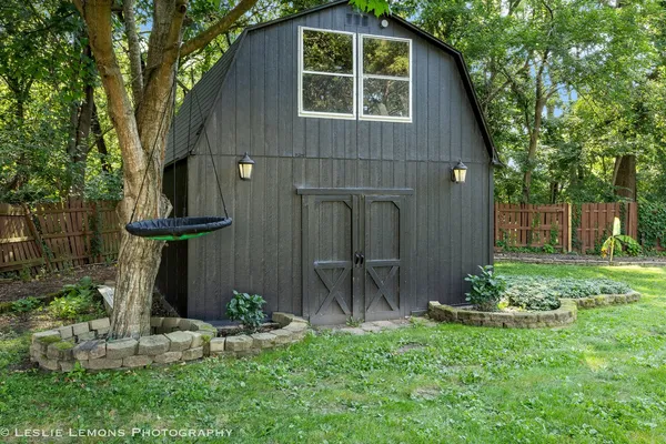 a front view of a house with a yard table and chairs