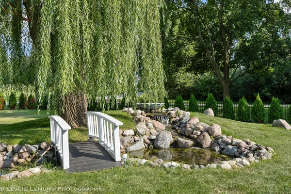 a backyard of a house with table and chairs