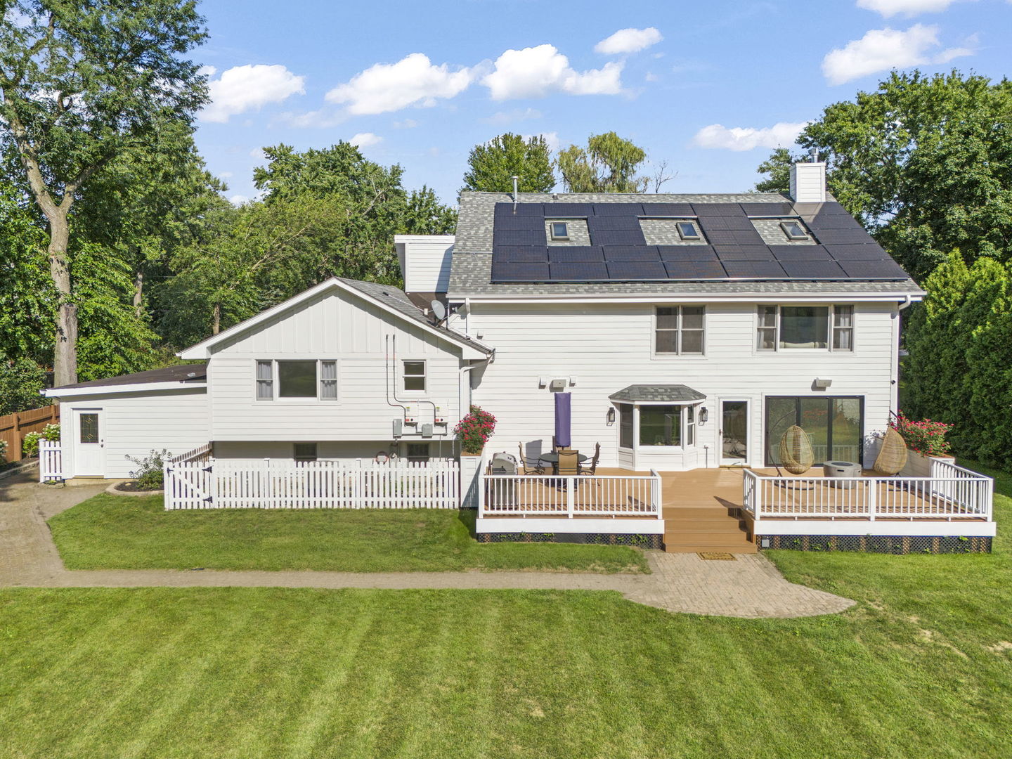 8S452 Bell Drive Naperville, IL 60565 - Photo 48 of 59 a front view of a house with a yard table and chairs