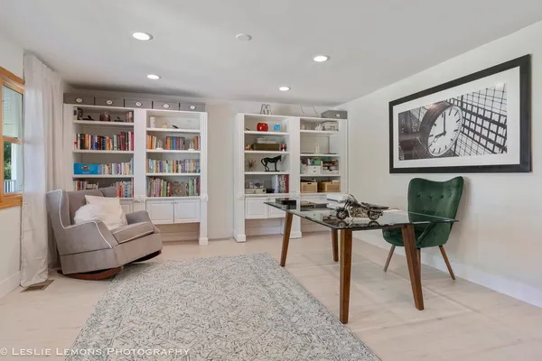 a large kitchen with stainless steel appliances granite countertop a large counter top a stove and a refrigerator with wooden floor