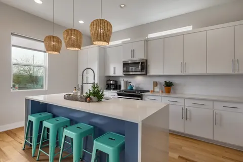 a kitchen with a sink cabinets and window