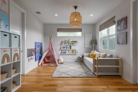 a living room with fireplace furniture and a wooden floor