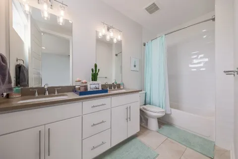 a bathroom with a double vanity sink and a mirror