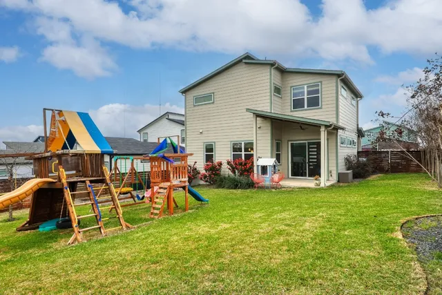 a view of a house with a yard and sitting area