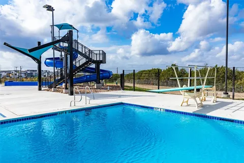 a view of a swimming pool with an outdoor space and seating area