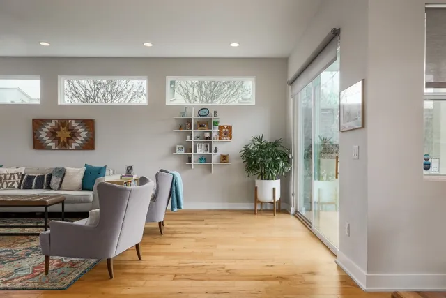 a living room with furniture and a potted plant