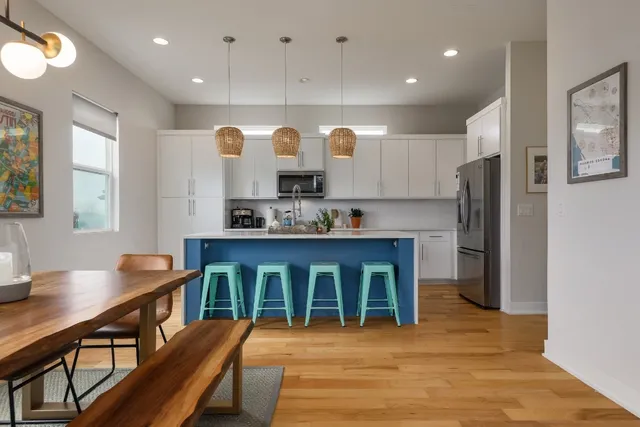 a kitchen with stainless steel appliances granite countertop a sink a stove and a refrigerator