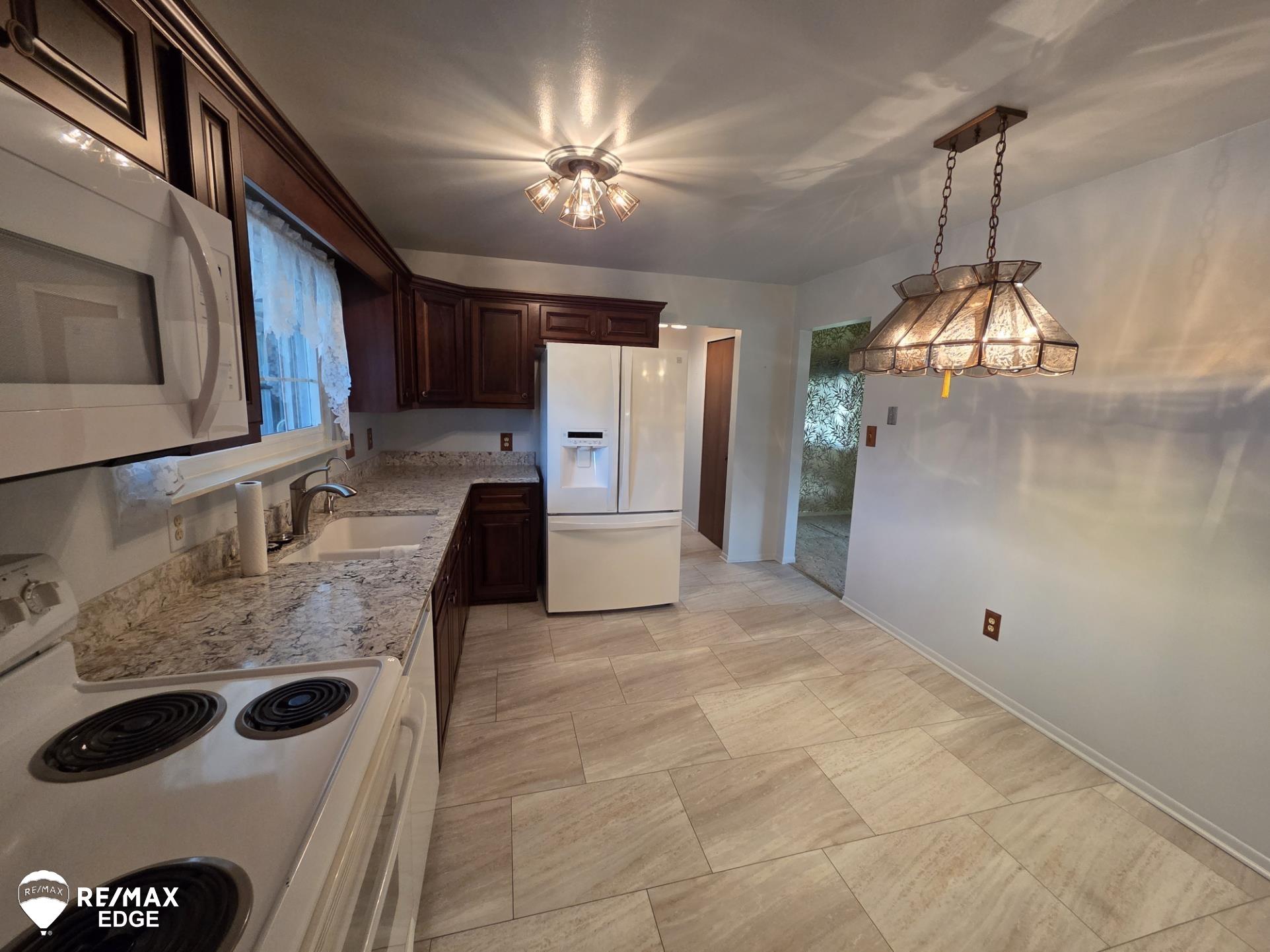 14020 North Road Fenton, MI 48430 - Photo 5 of 52 Updated Kitchen with Quartz Counter tops, Maple Cabinetry, H2O Luxury vinyl Flooring, new appliances