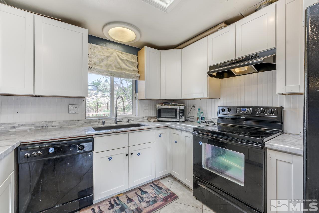 3645 Bryan Street Reno, NV 89503 - Photo 11 of 38 a kitchen with cabinets appliances and a window