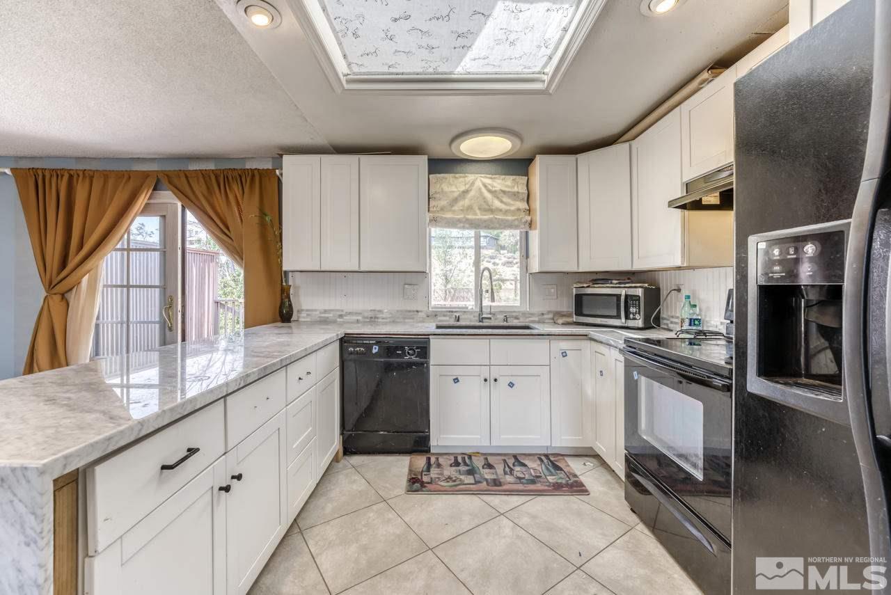 3645 Bryan Street Reno, NV 89503 - Photo 12 of 38 a kitchen with stainless steel appliances granite countertop a stove a sink and a refrigerator