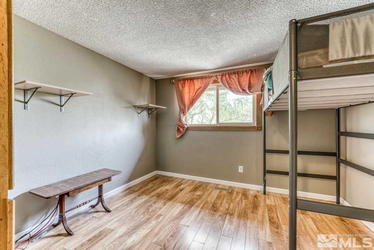 3645 Bryan Street Reno, NV 89503 - Photo 18 of 38 a view of an empty room with a window and wooden floor