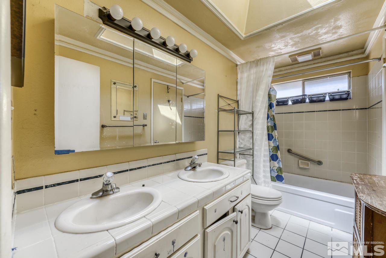 3645 Bryan Street Reno, NV 89503 - Photo 20 of 38 a bathroom with a granite countertop sink toilet and shower