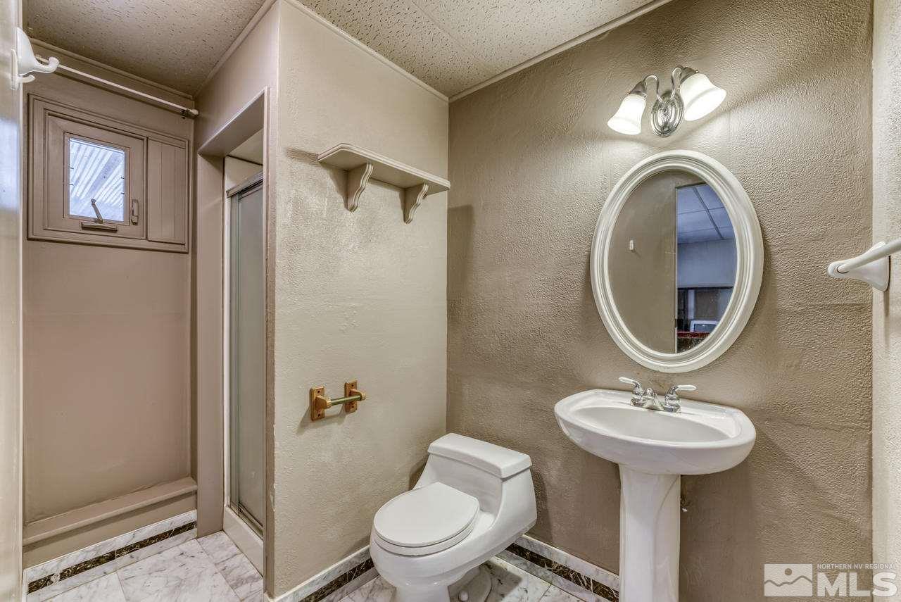 3645 Bryan Street Reno, NV 89503 - Photo 25 of 38 a bathroom with a toilet a sink and a mirror