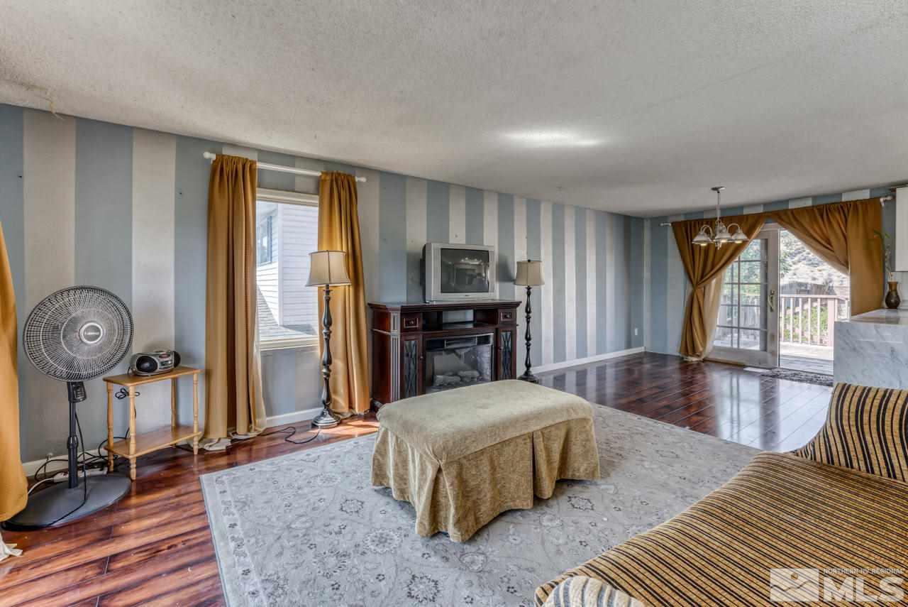 3645 Bryan Street Reno, NV 89503 - Photo 5 of 38 a spacious bedroom with a bed a table and large windows