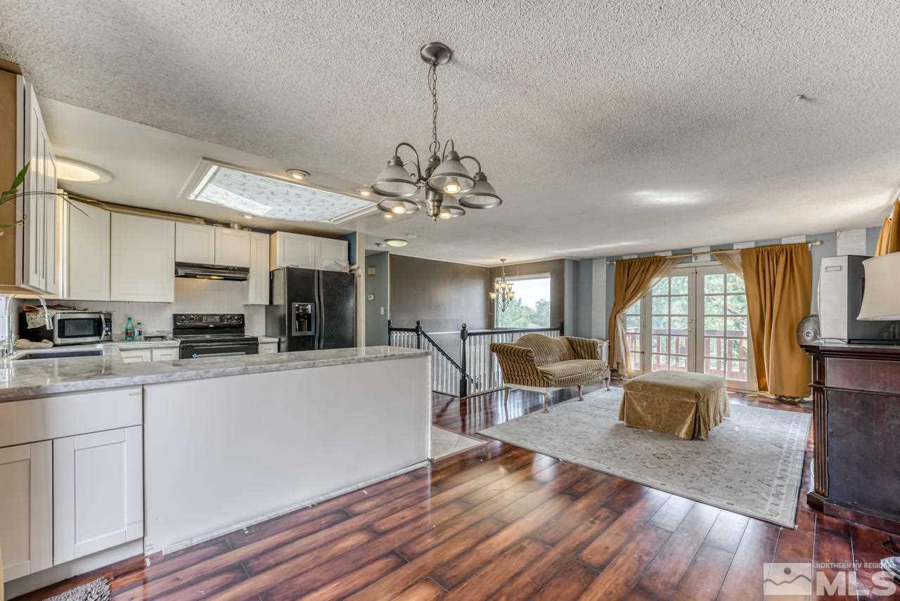 3645 Bryan Street Reno, NV 89503 - Photo 8 of 38 a living room with stainless steel appliances granite countertop furniture and a wooden floor