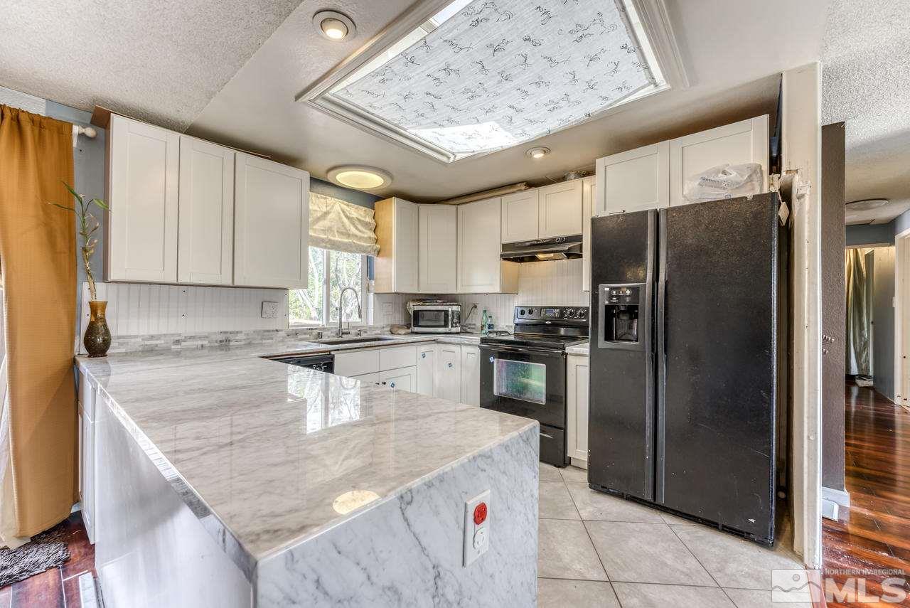 3645 Bryan Street Reno, NV 89503 - Photo 10 of 38 a kitchen with a refrigerator a sink and dishwasher