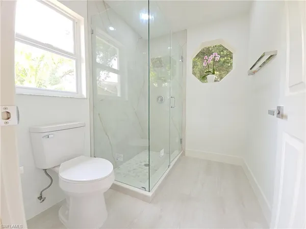 a bathroom with a toilet and a shower